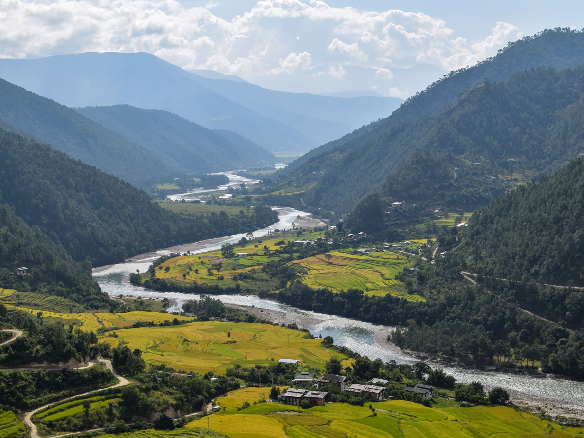 River winding through farming villages fields in Bhutan valley