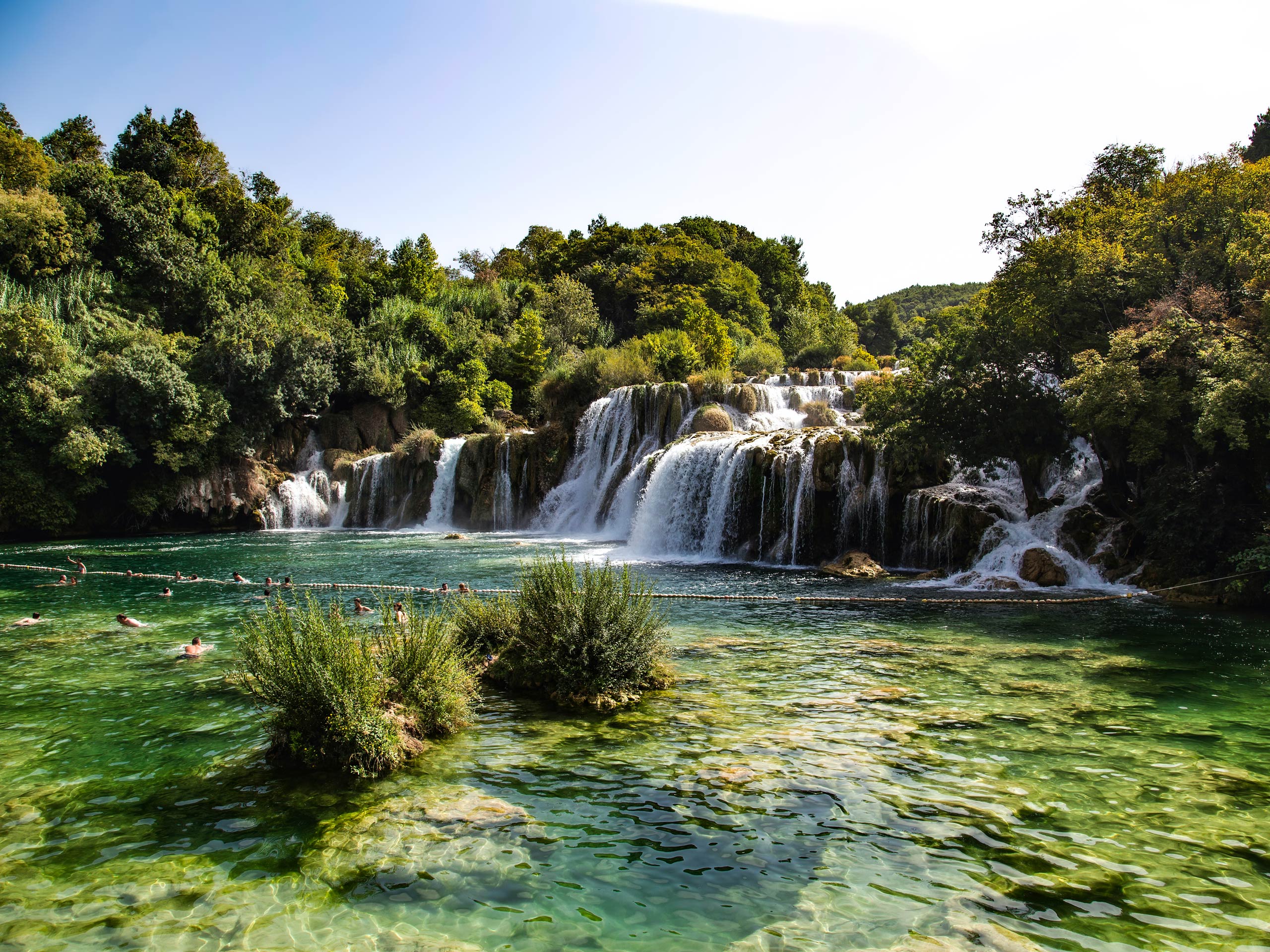 Swimming under waterfalls in Plitvice National Park Croatia