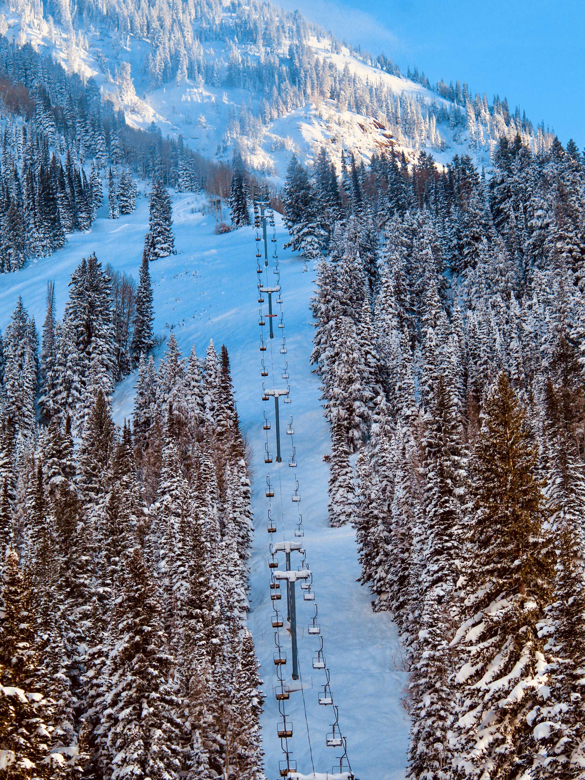 Snowbird Mountain Resort chairlift climbing up snowy mountain Utah skiing snowboarding