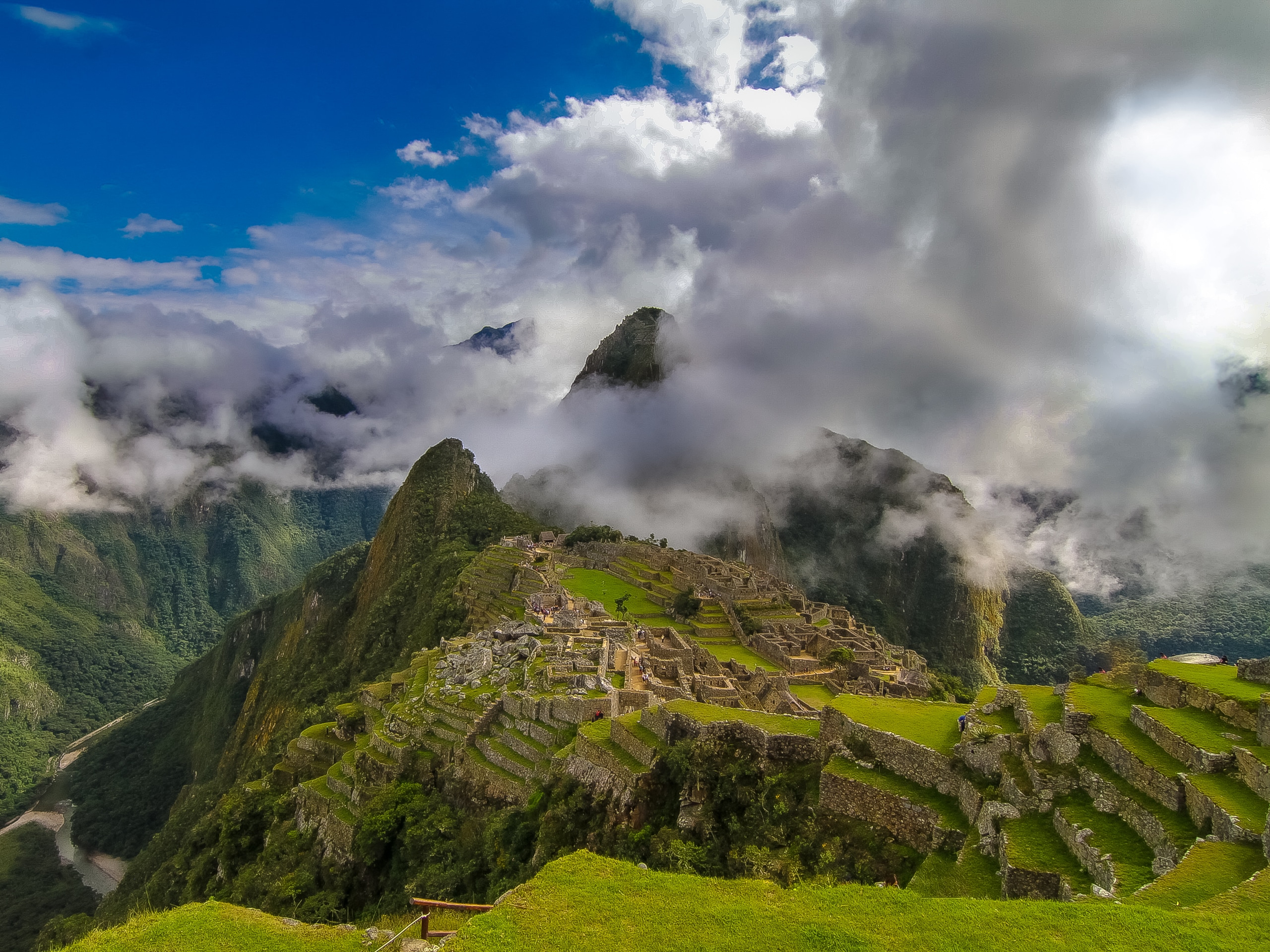 Low clouds hanging over historic ancient Machu Picchu village ruins Peru