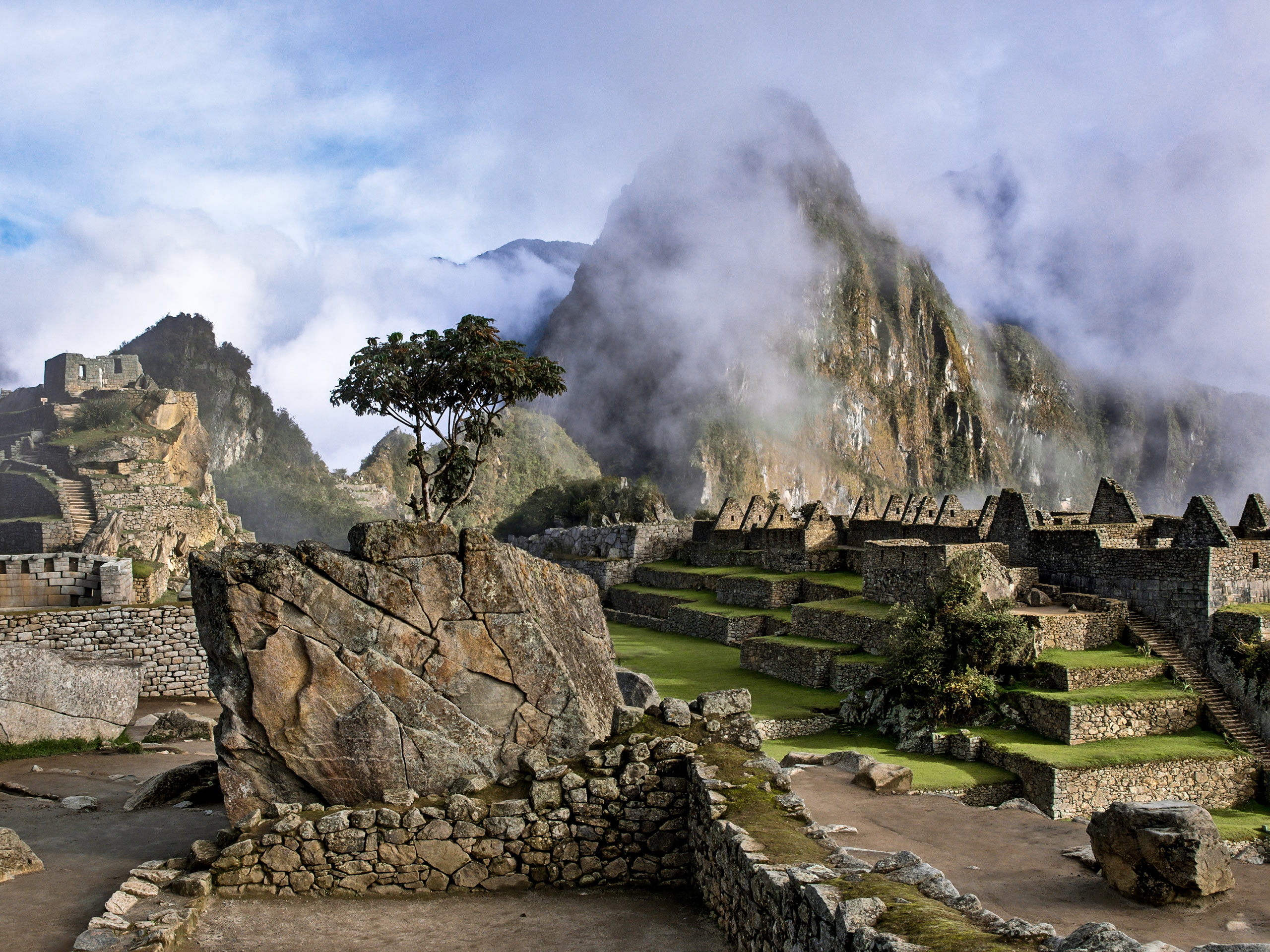 Ancient Machu Picchu ruins in the fog hiking trekking in Peru