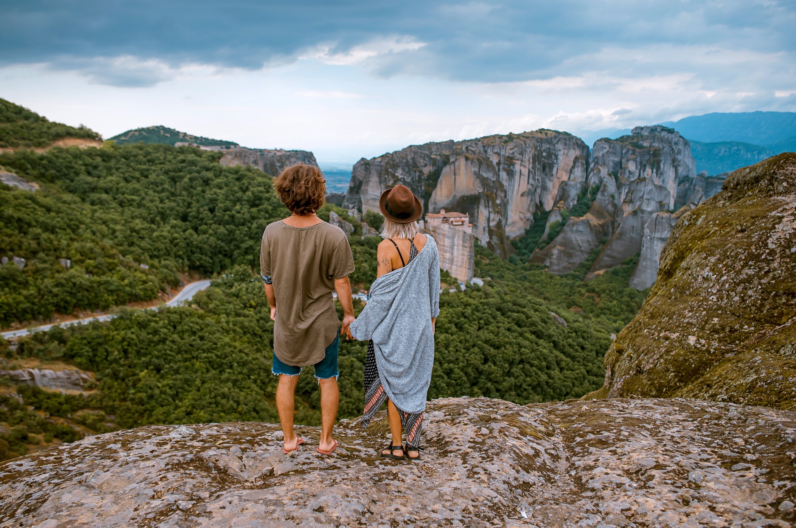 Couple enjoying the beautiful views of the rock formations in Meteora, Greece